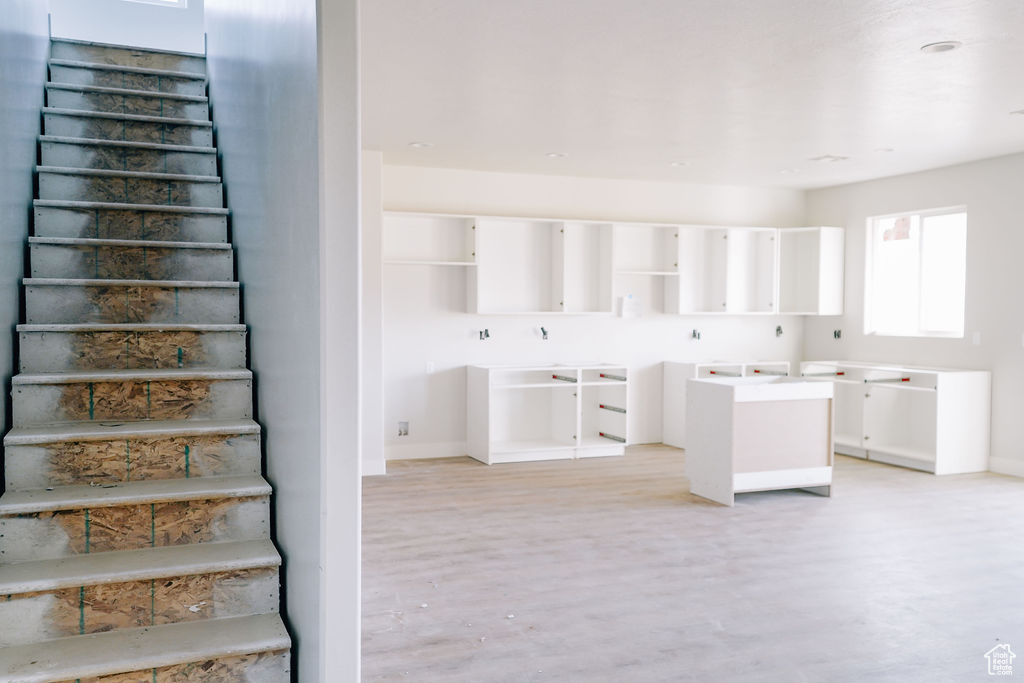 Interior space with light hardwood / wood-style flooring and cabinets