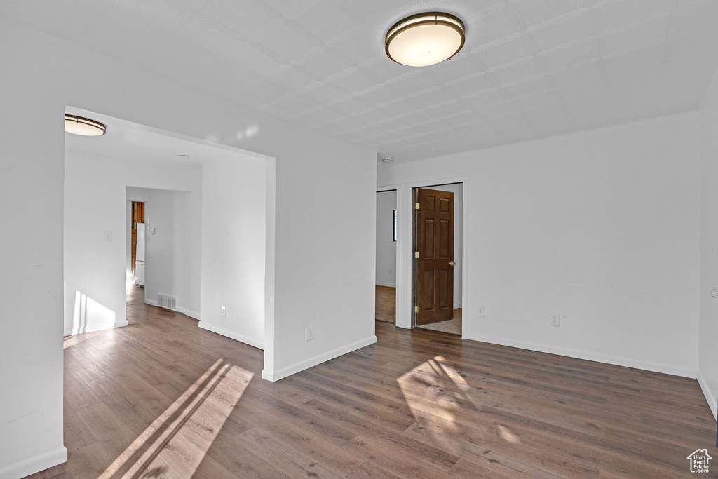 Unfurnished room featuring dark hardwood / wood-style flooring