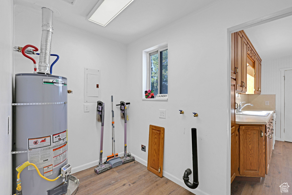 Utilities with strapped water heater, sink, and electric panel