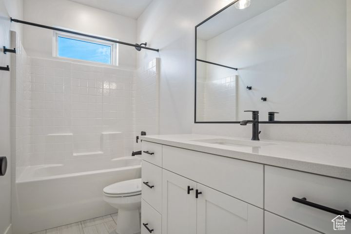 Full bathroom featuring shower / bath combination, vanity, and toilet