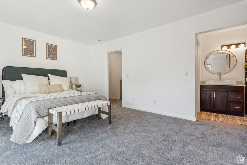 Bedroom with connected bathroom and carpet floors