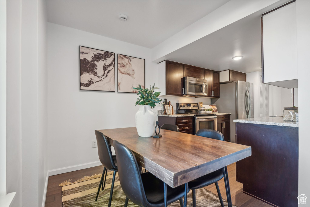 Dining area with dark hardwood / wood-style floors