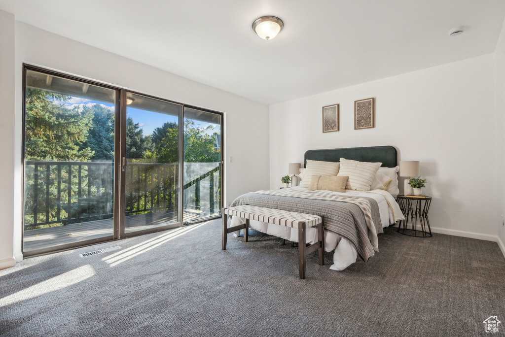 Bedroom featuring access to exterior and dark carpet