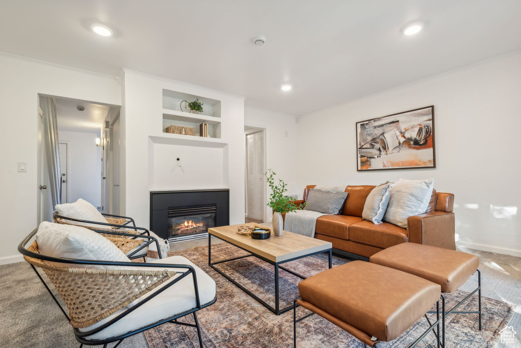 Living room with carpet and ornamental molding