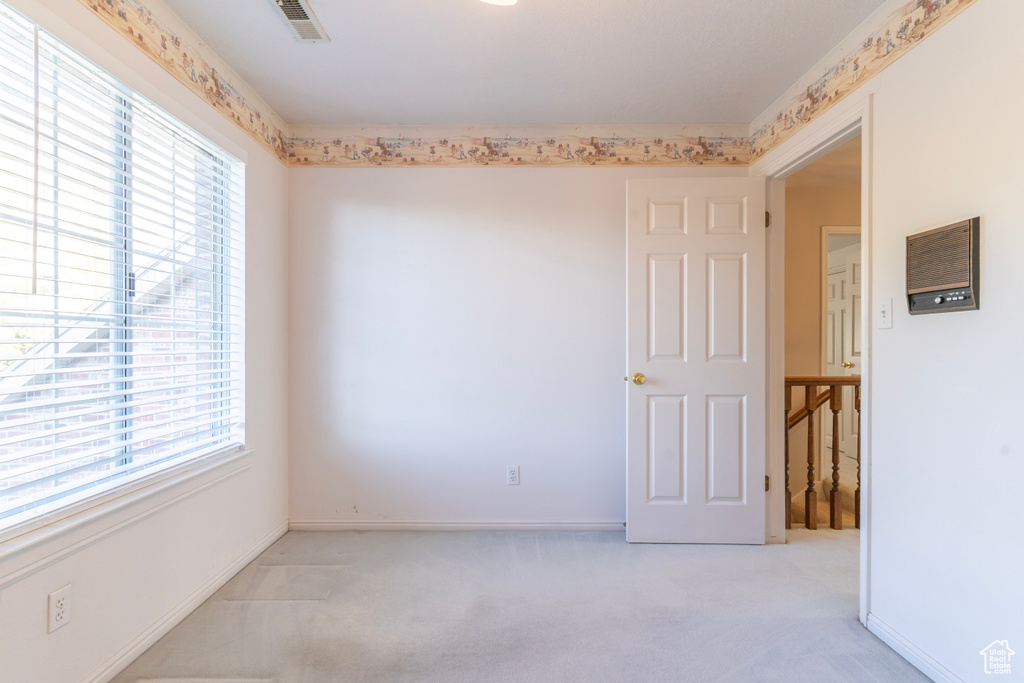 Carpeted empty room with a wealth of natural light