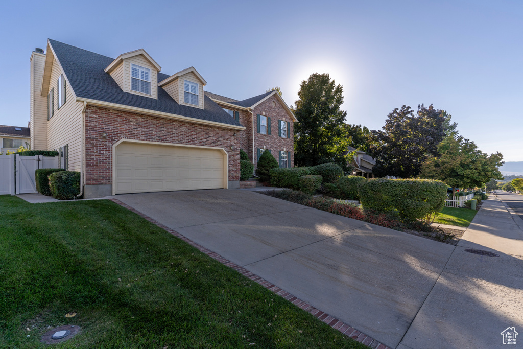 View of front of home with a front lawn and a garage