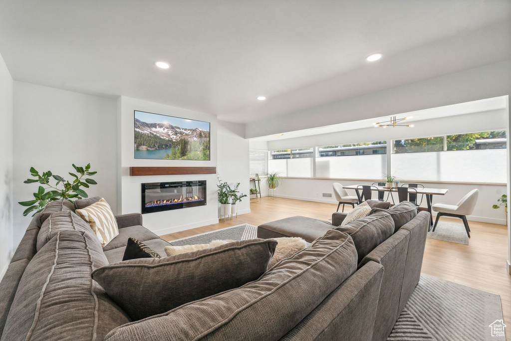 Living room with light hardwood / wood-style flooring and plenty of natural light