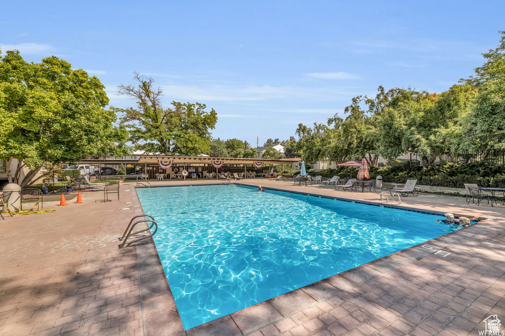 View of swimming pool with a patio area