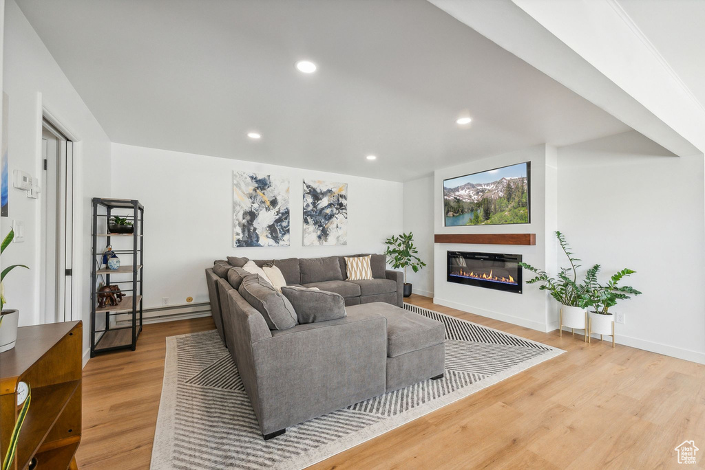 Living room featuring baseboard heating and light wood-type flooring