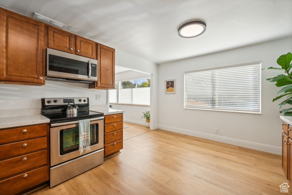 Kitchen featuring appliances with stainless steel finishes and light wood-type flooring