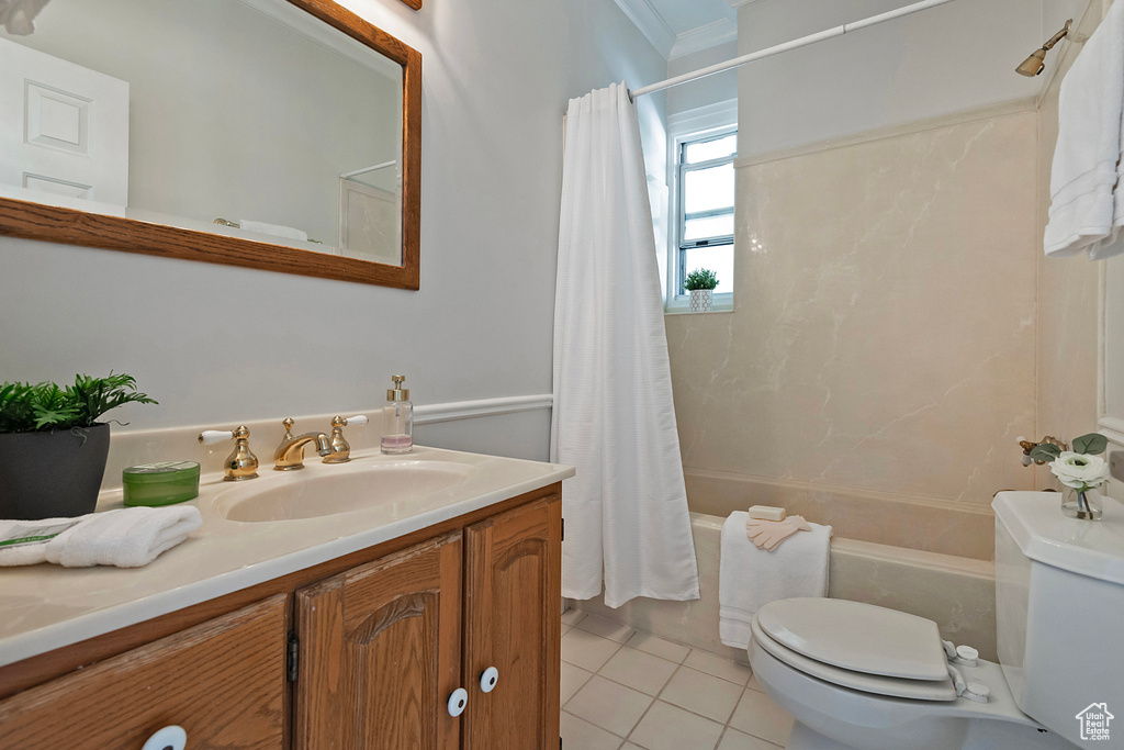 Full bathroom featuring toilet, tile patterned flooring, crown molding, shower / tub combo with curtain, and vanity