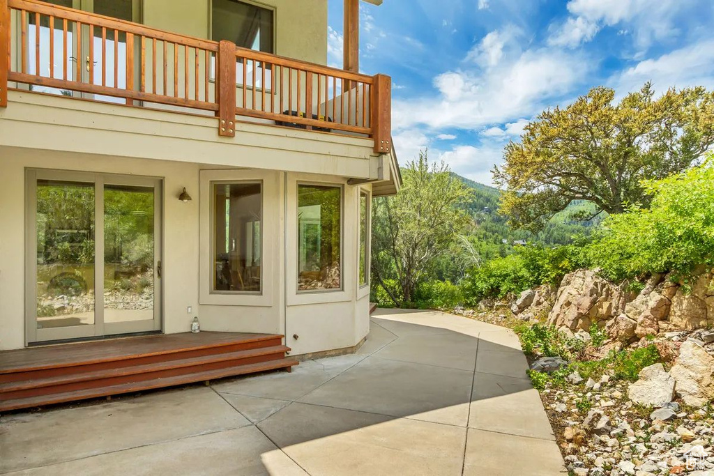 View of patio featuring a mountain view and a balcony