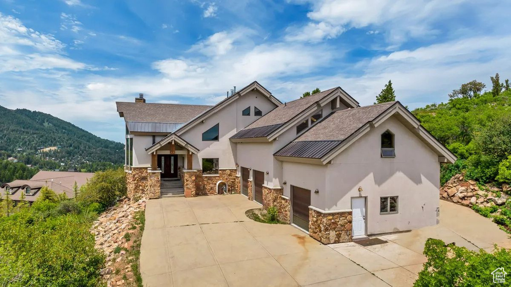 View of front facade featuring a garage and a mountain view