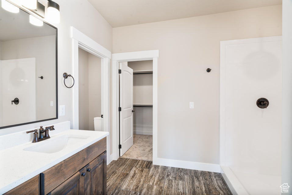 Bathroom with vanity and hardwood / wood-style flooring