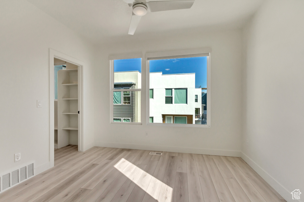 Spare room featuring ceiling fan and light wood-type flooring