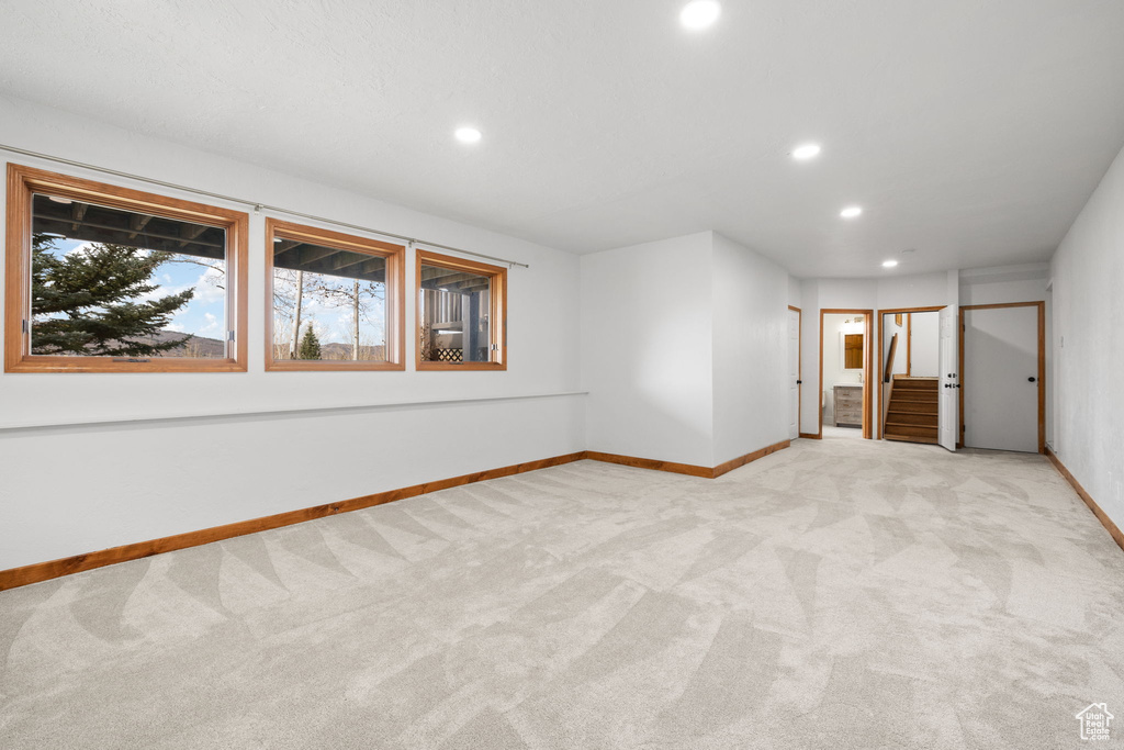 Unfurnished room with light colored carpet