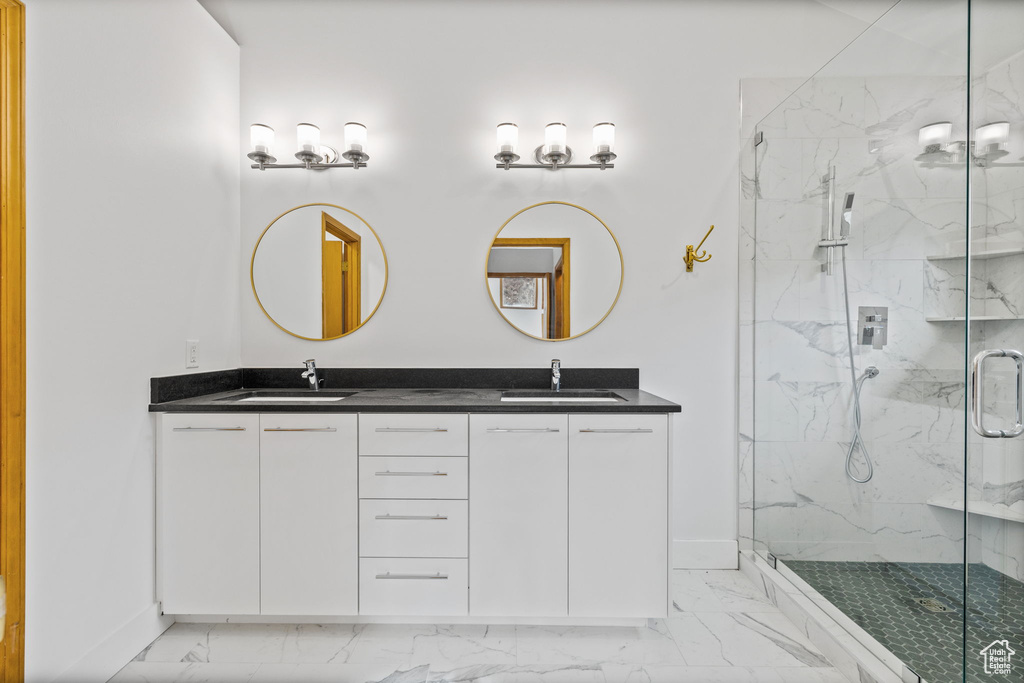 Bathroom with vanity and a shower with shower door