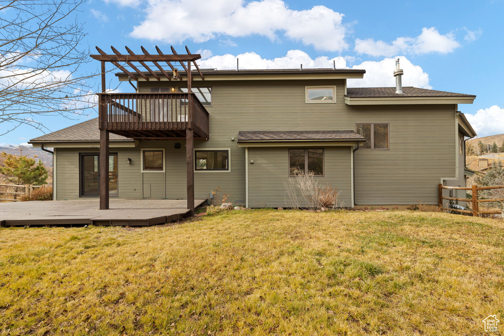 Back of house featuring a yard and a deck