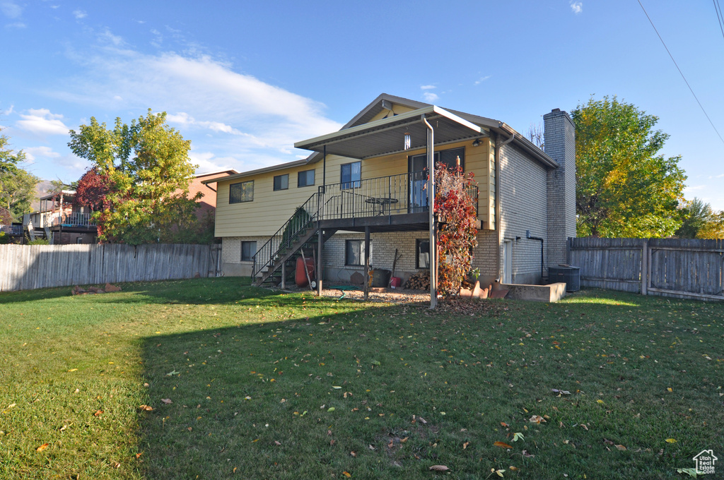 Back of property featuring a lawn