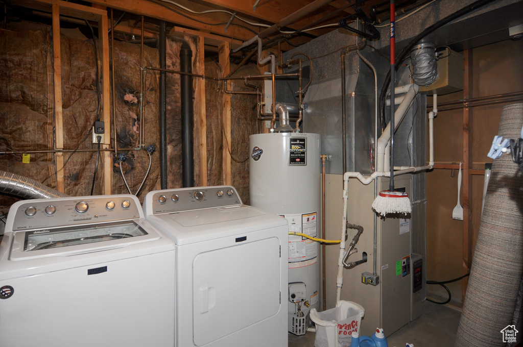 Laundry room with water heater, washer and dryer, and heating unit