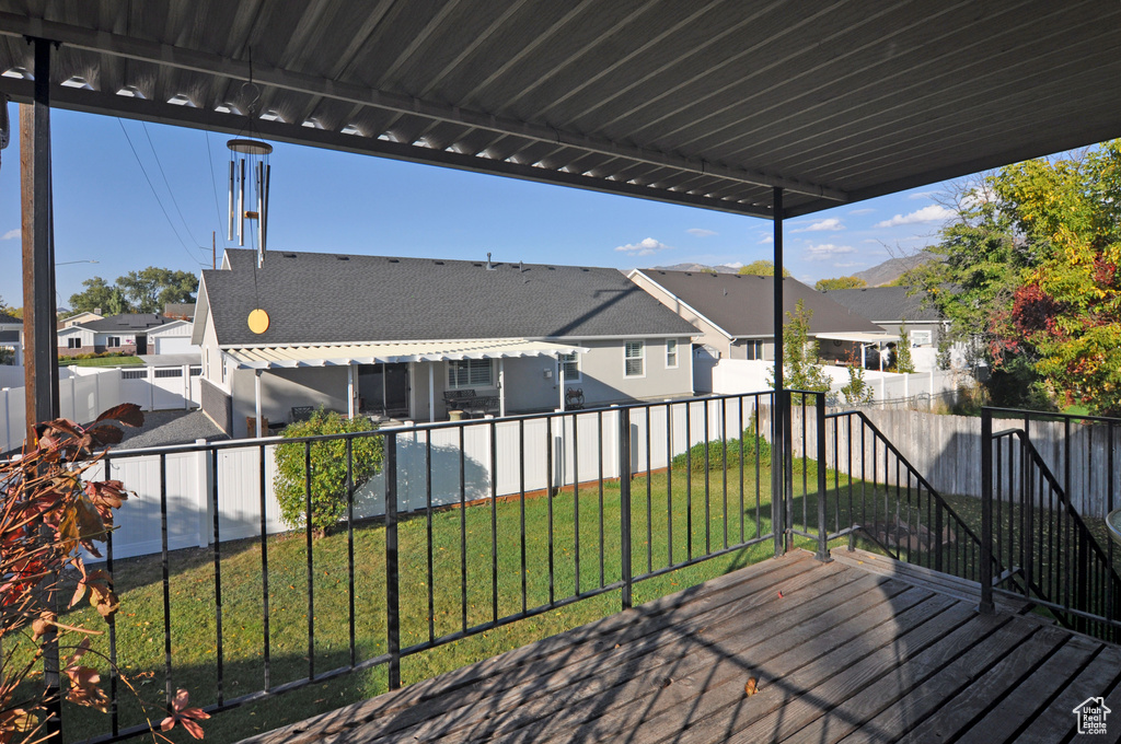 Wooden terrace featuring a yard