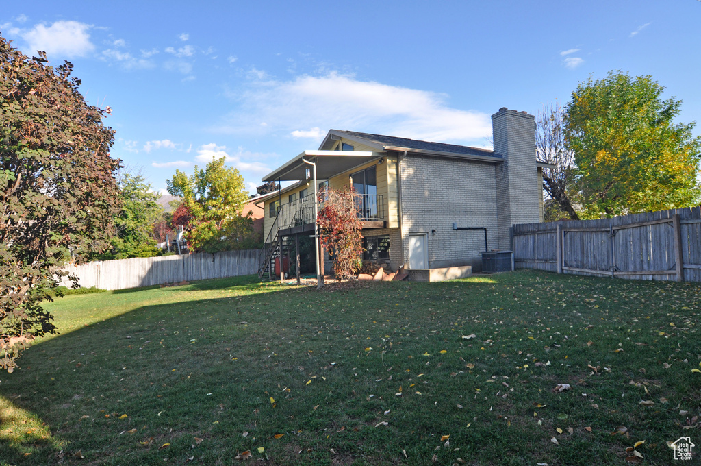 Back of property featuring a lawn