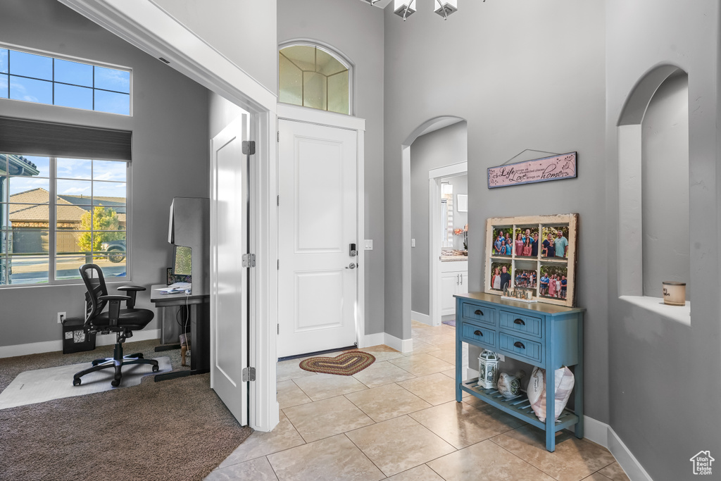 Tiled entrance foyer featuring a high ceiling