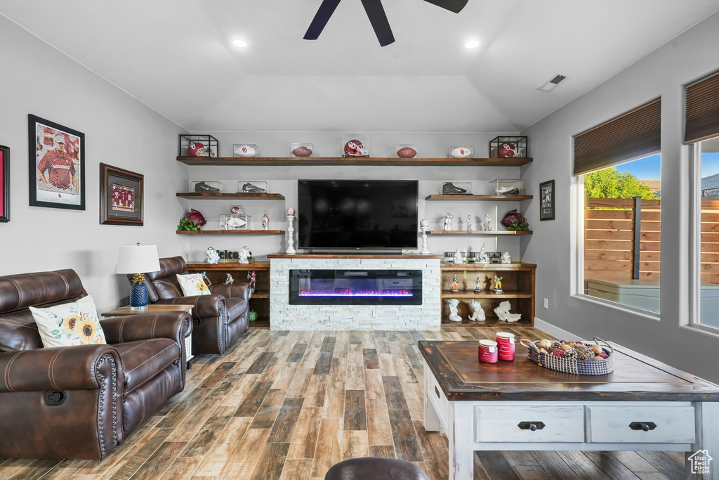 Living room with lofted ceiling, dark wood-type flooring, and ceiling fan