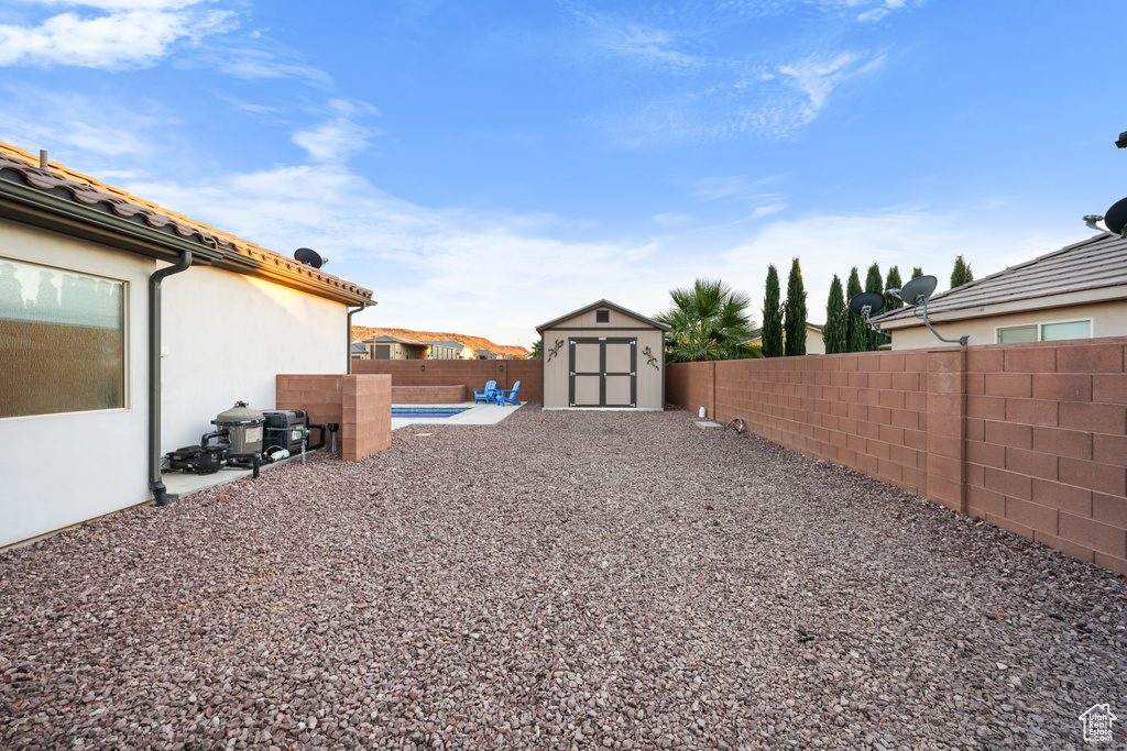 View of yard with a storage unit