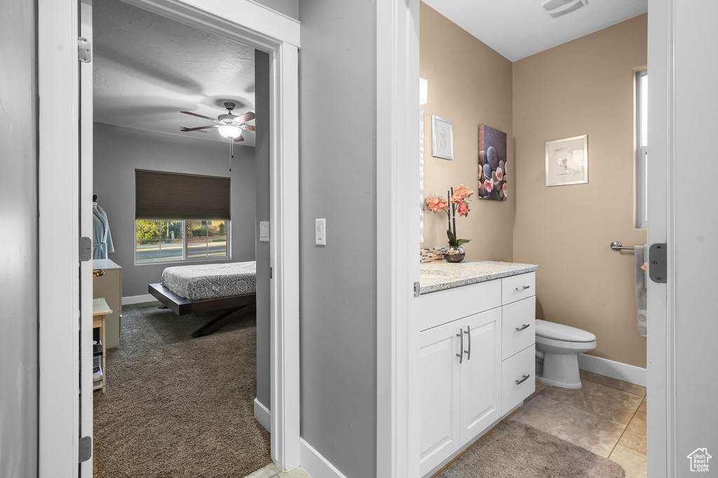 Bathroom with vanity, tile patterned flooring, toilet, and ceiling fan