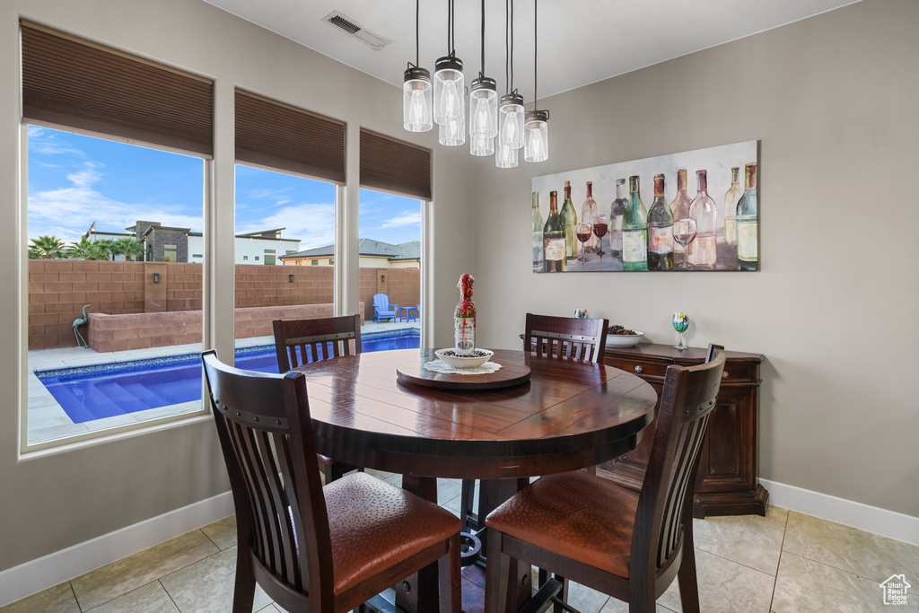 Dining space featuring light tile patterned floors