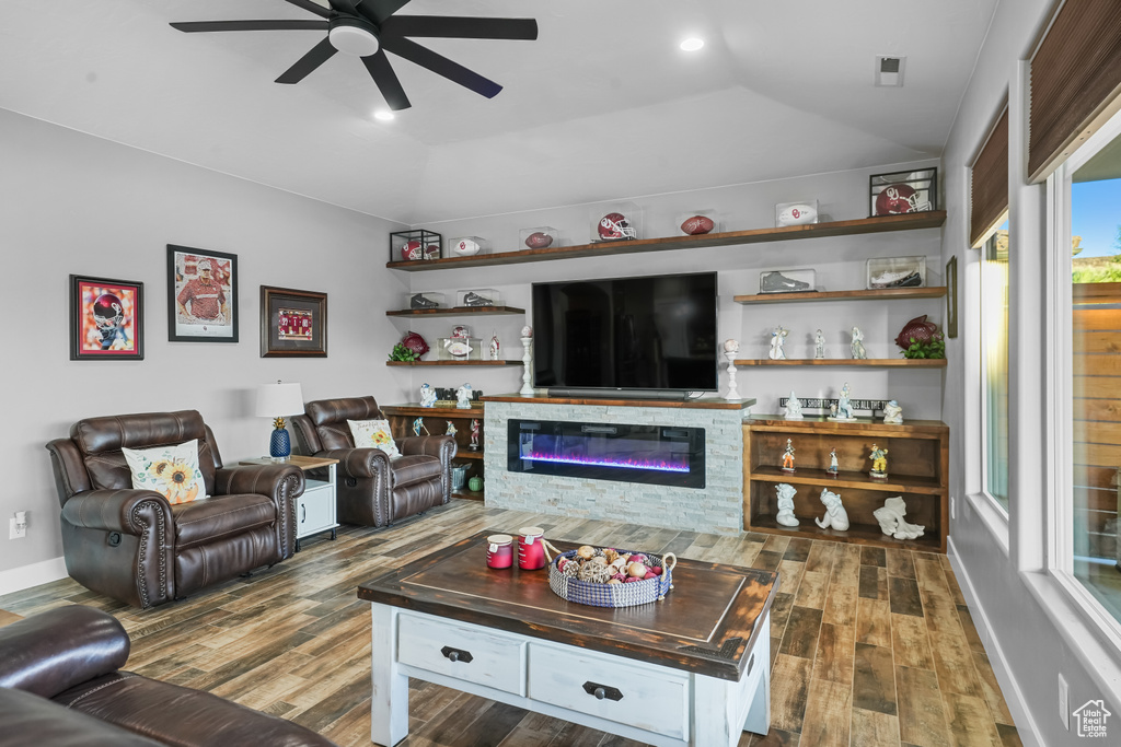 Living room featuring dark hardwood / wood-style floors, ceiling fan, and vaulted ceiling