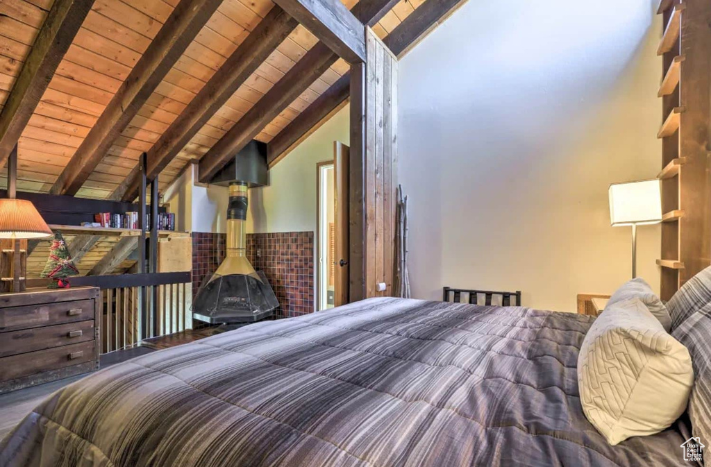 Bedroom featuring vaulted ceiling with beams and wooden ceiling