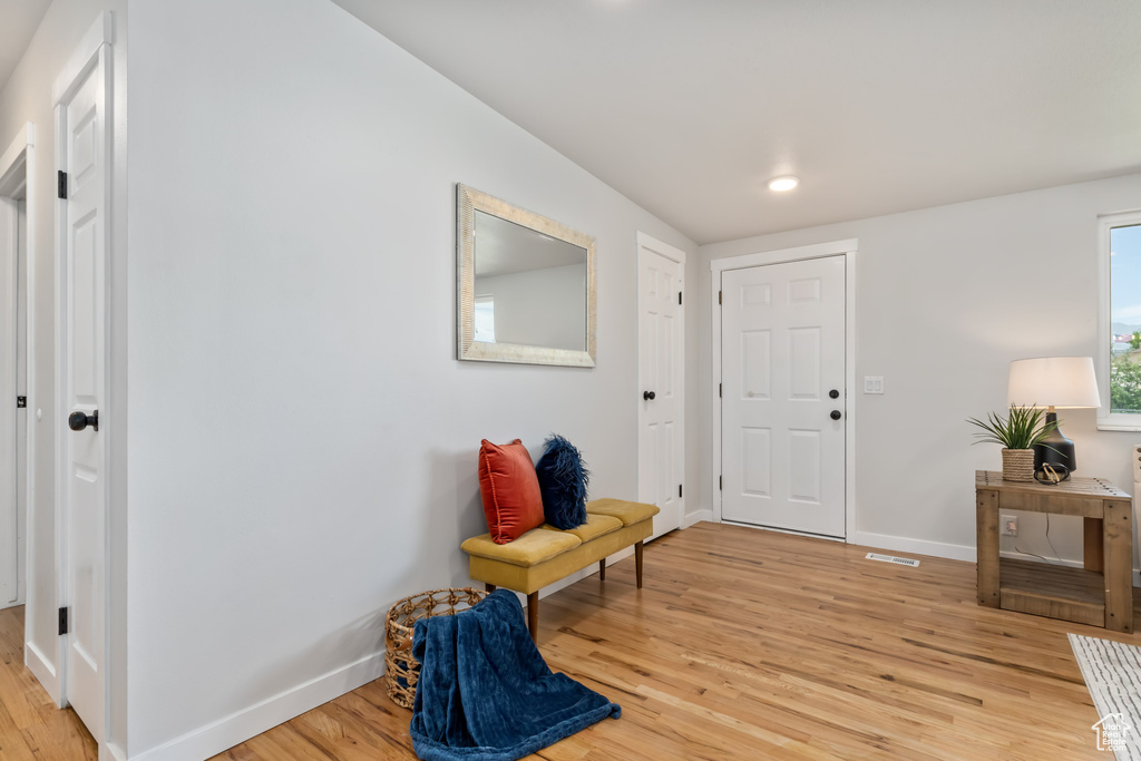 Entrance foyer with light wood-type flooring