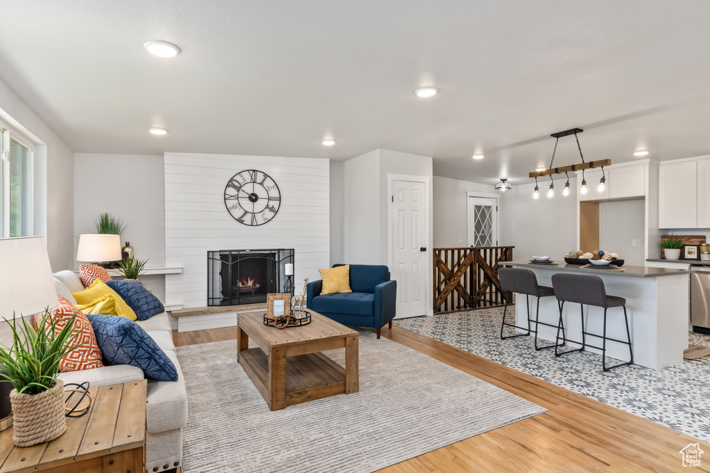 Living room with light hardwood / wood-style flooring and a fireplace