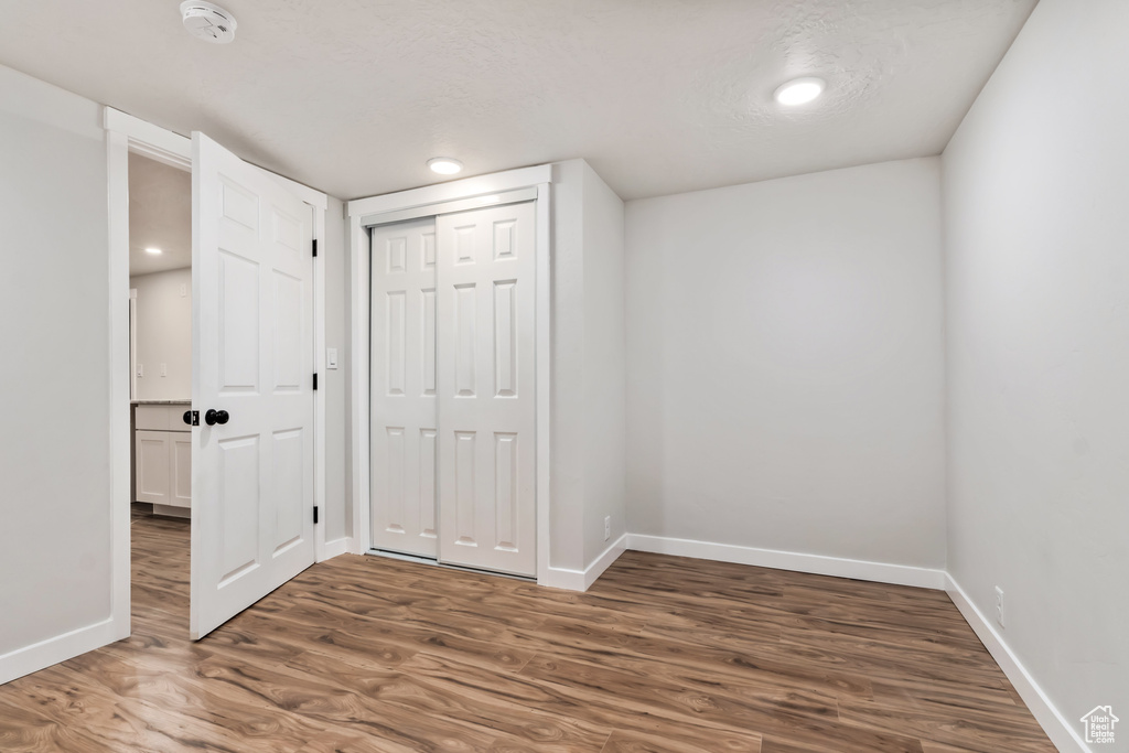 Interior space featuring a textured ceiling and dark hardwood / wood-style floors