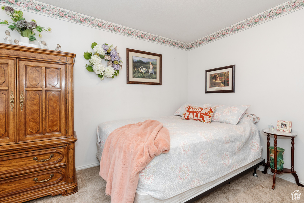 Bedroom featuring light colored carpet