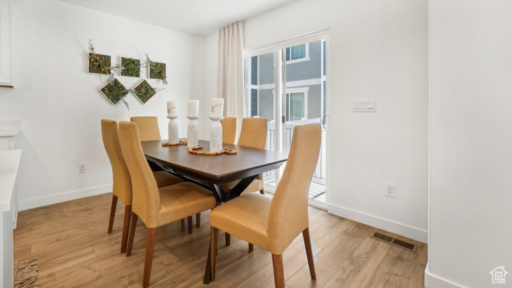 Dining area with light wood-type flooring