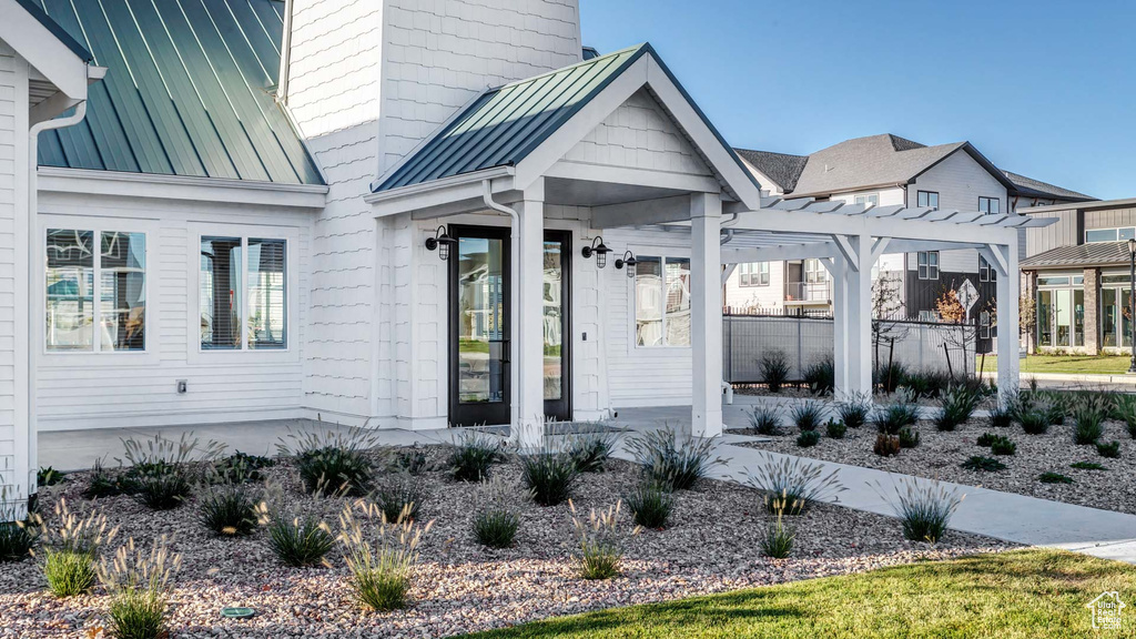 View of exterior entry featuring a pergola