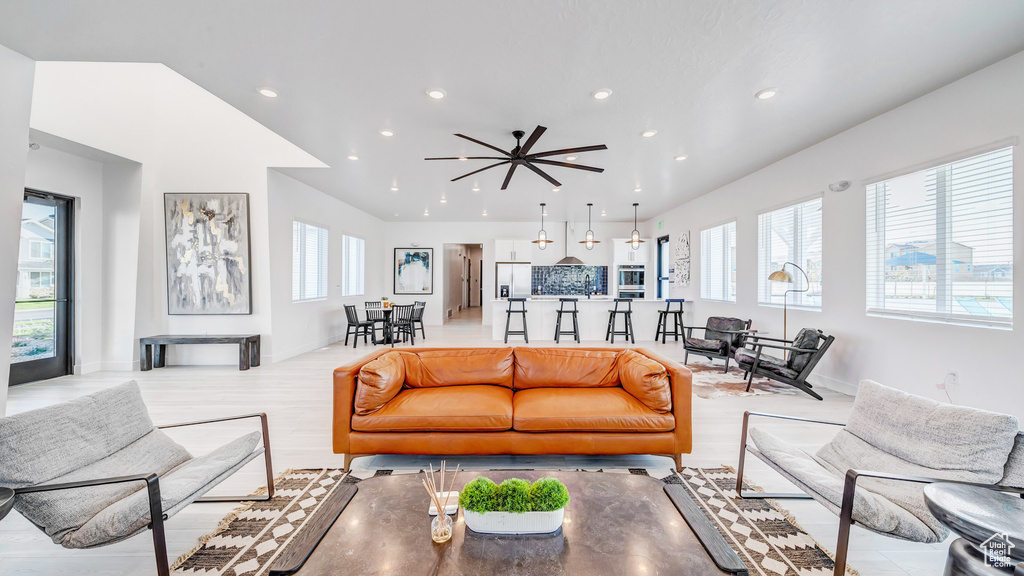 Living room featuring light hardwood / wood-style floors, a healthy amount of sunlight, and ceiling fan