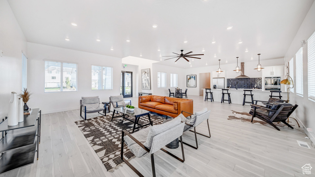 Living room with light wood-type flooring and ceiling fan