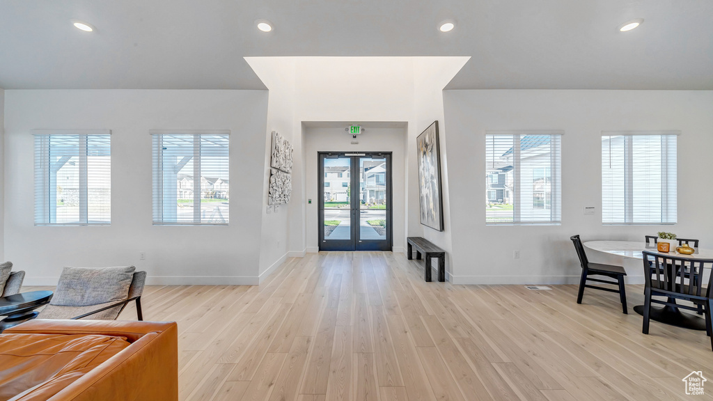 Foyer entrance featuring light hardwood / wood-style flooring, french doors, and a wealth of natural light