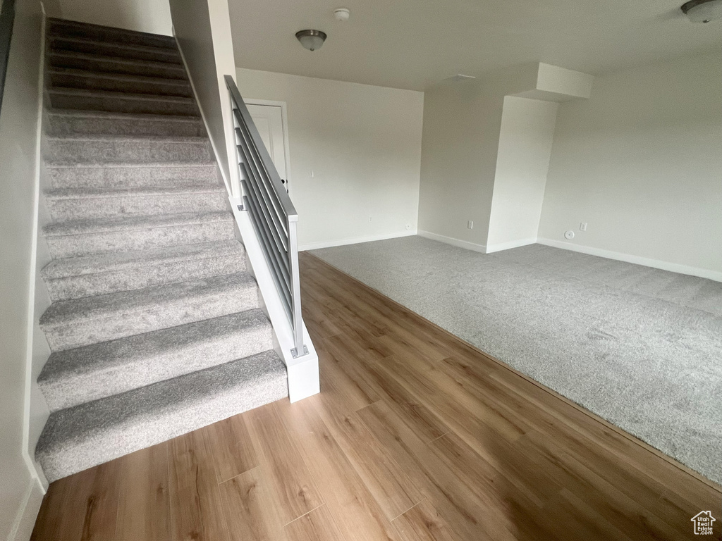 Stairway with hardwood / wood-style floors