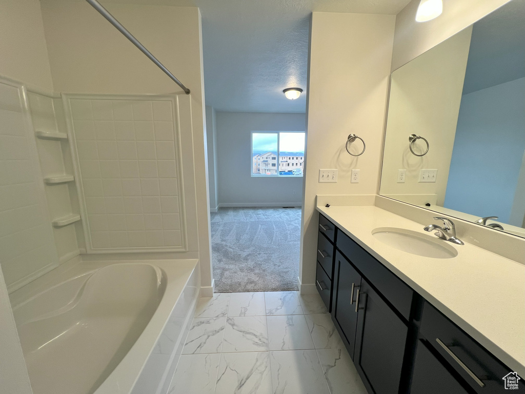 Bathroom with vanity and a textured ceiling