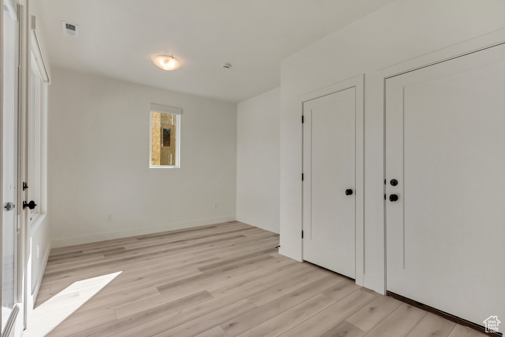 Unfurnished bedroom with light hardwood / wood-style flooring