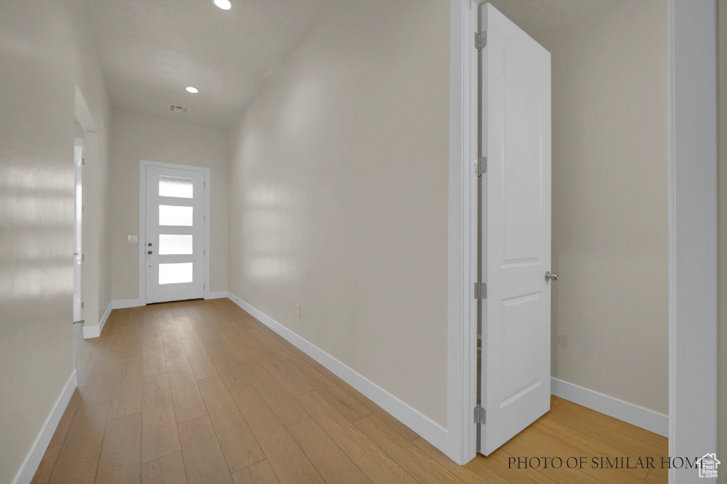 Hall with light hardwood / wood-style flooring