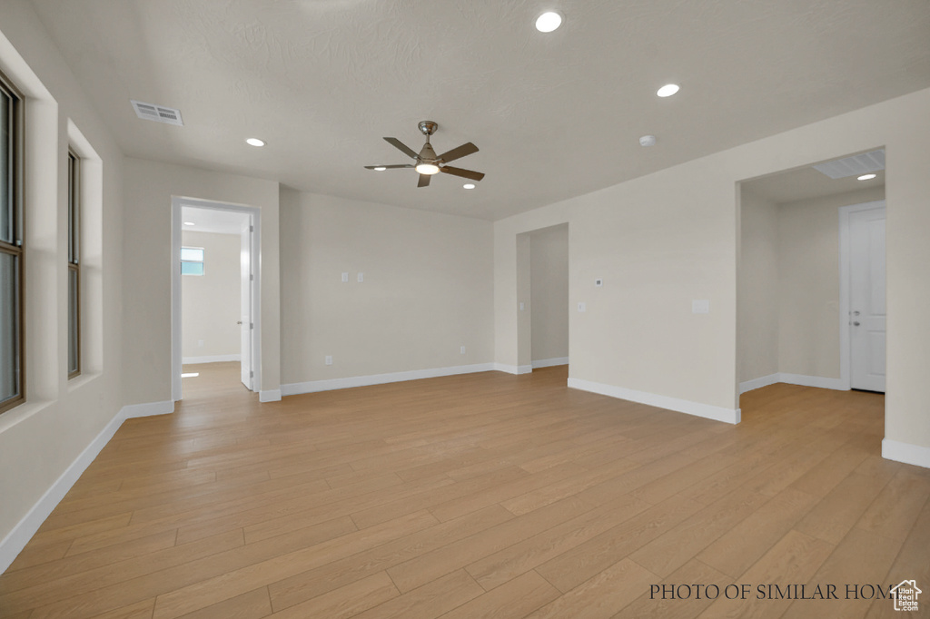 Empty room with light wood-type flooring and ceiling fan