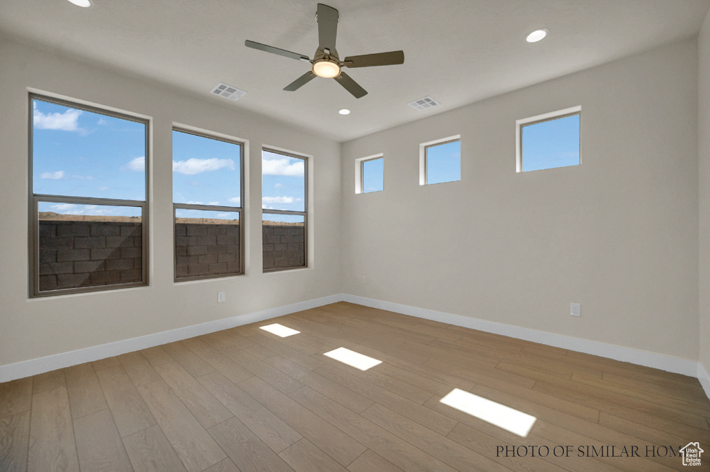 Spare room featuring ceiling fan and light wood-type flooring