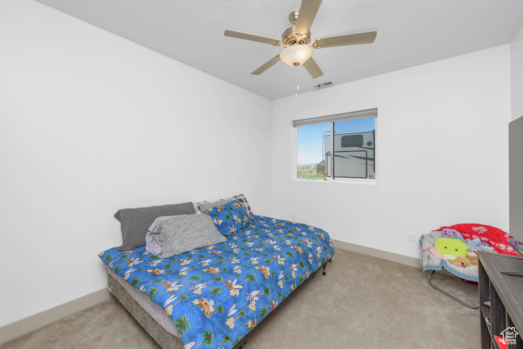 Bedroom with ceiling fan and carpet flooring