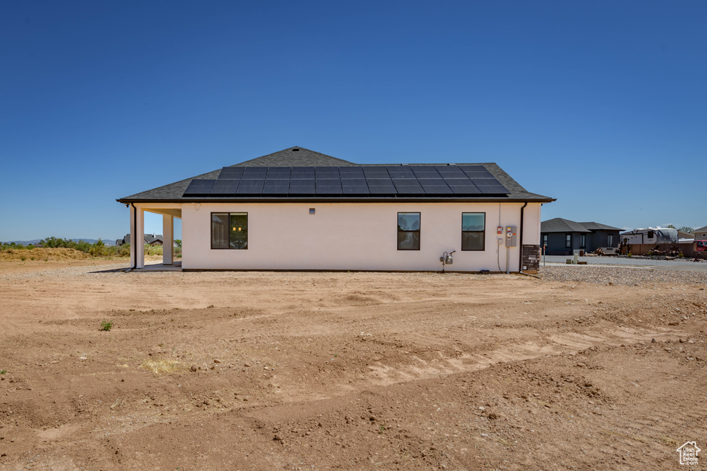 Rear view of house with solar panels